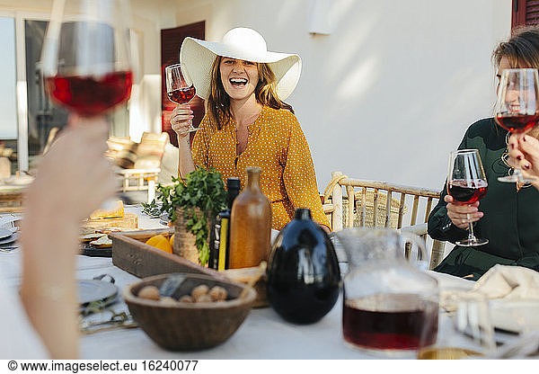 Happy woman holding wineglass