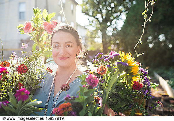 happy woman in a flower garden in the sunshine