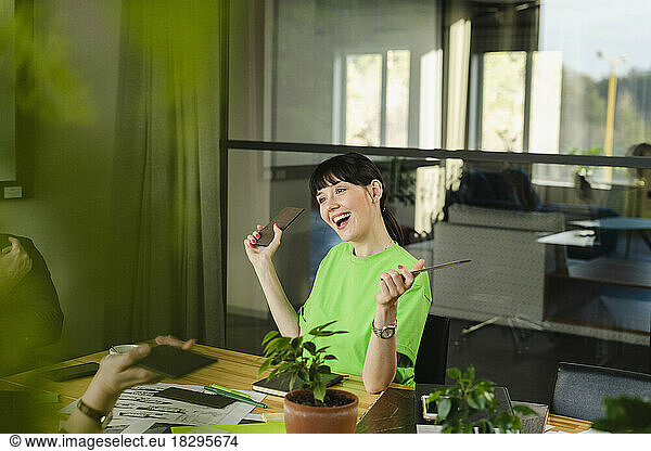 Happy woman in green t-shirt in conference room