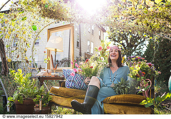 happy woman outdoors laughing on couch