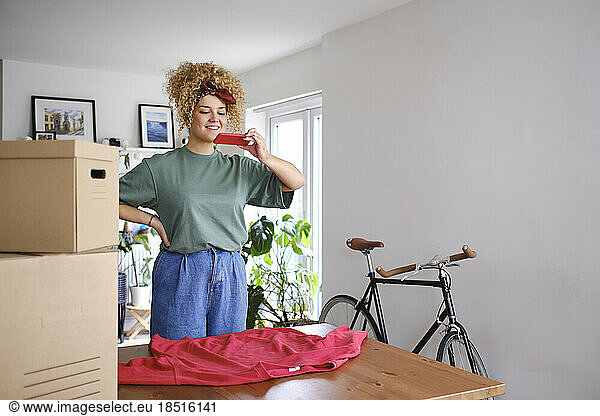 Happy woman photographing through smart phone