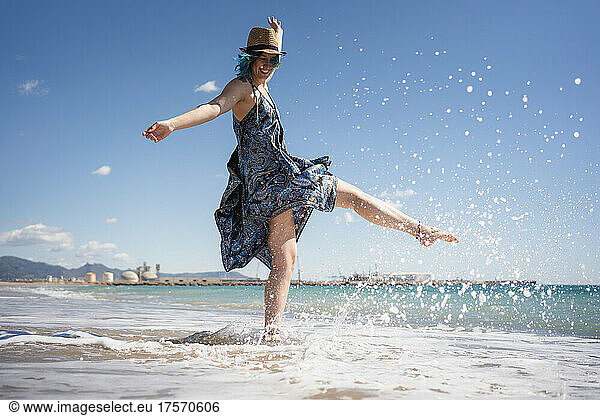 Happy woman plays free on the seashore