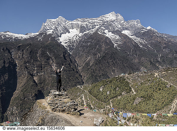 Happy woman raising arms near Namche Bazaar  Himalayas  Solo Khumbu  Nepal