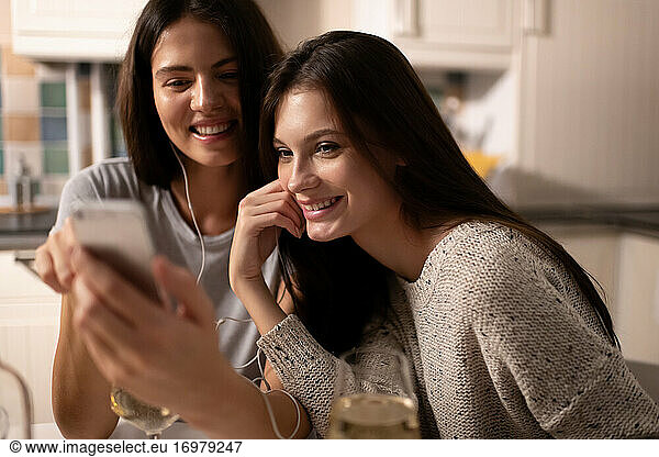 Happy woman sharing playlist with friend