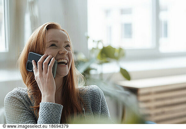 Happy woman talking on smart phone