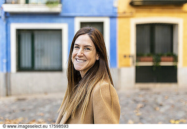 Happy woman with brown hair in city
