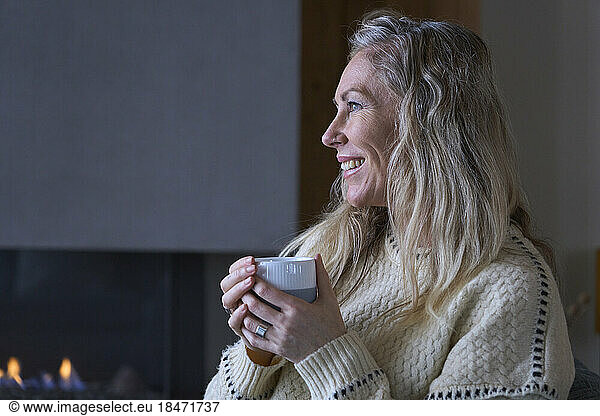Happy woman with coffee cup at home