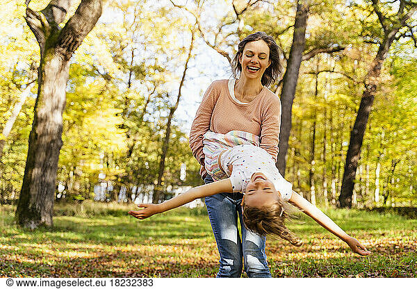 Happy woman with daughter enjoying in park