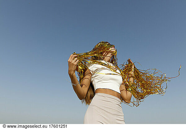Happy woman with gold tinsel in her hair