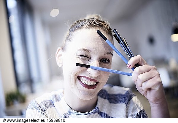 Happy woman with pencils