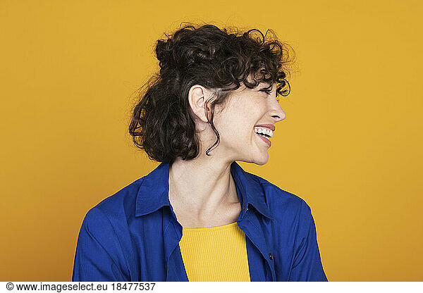 Happy woman with short hair against colored background
