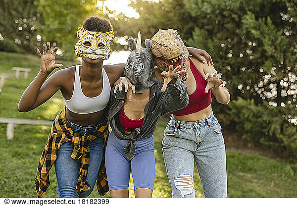 Happy women wearing animal mask having fun at park