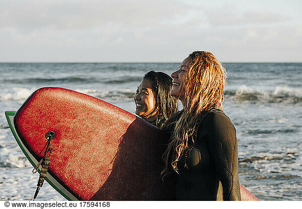 Happy women with surfboards at beach  Gran Canaria  Canary Islands