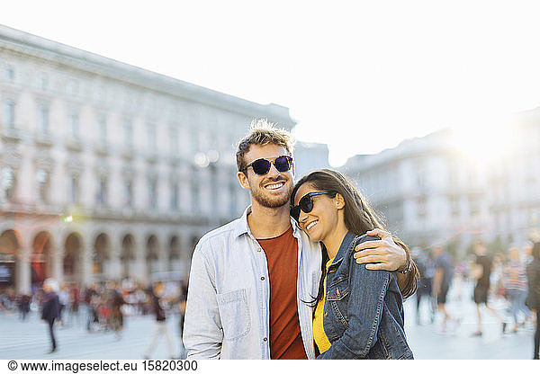 Happy young couple on a square in the city at sunset  Milan  Italy