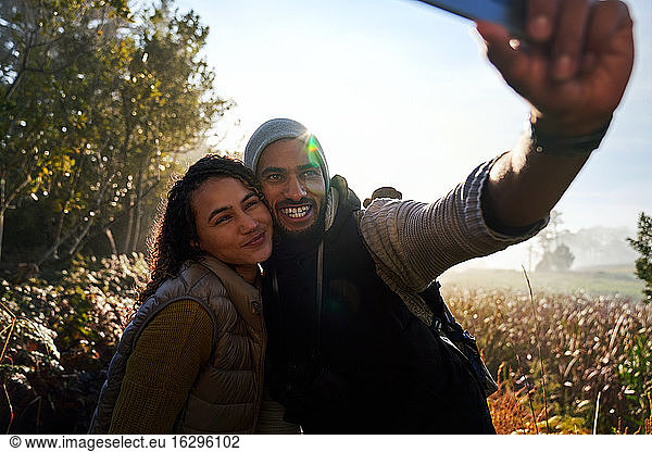 Happy young couple taking selfie on hike