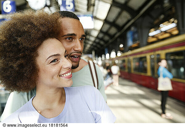 Happy young couple waiting for commuter train