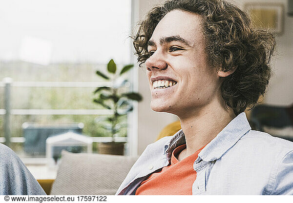 Happy young man with brown hair at home
