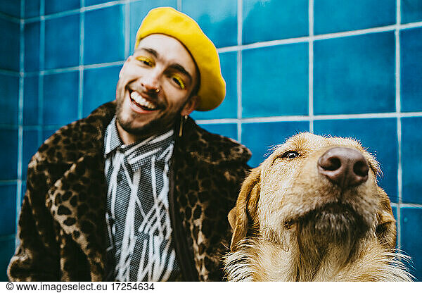 Happy young man with Golden Retriever dog
