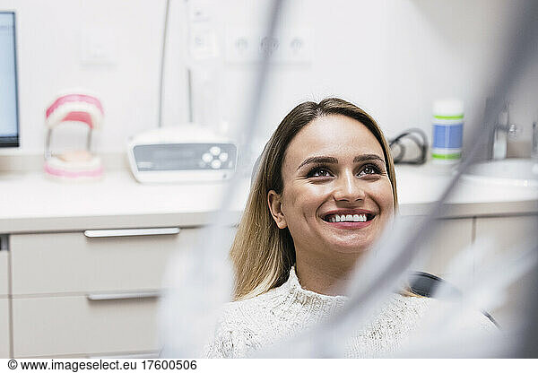 Happy young woman at dentist clinic