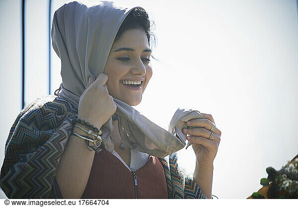 Happy young woman in headscarf