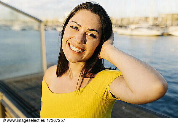 Happy young woman on pier