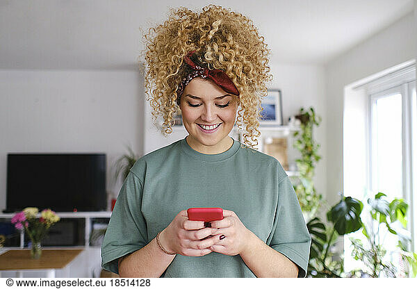 Happy young woman using smart phone