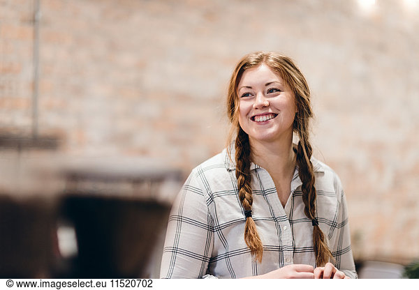 Happy young woman with pigtails