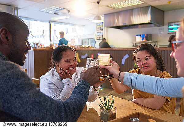 Happy young women with Down Syndrome in cafe