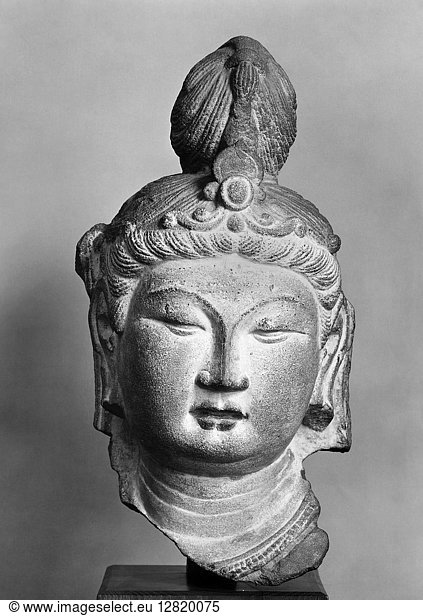 HEAD OF BODHISATTVA. Head of a bodhisattava from the caves of T'ien Lung Shan  China. Sandstone  T'ang dynasty  c740.