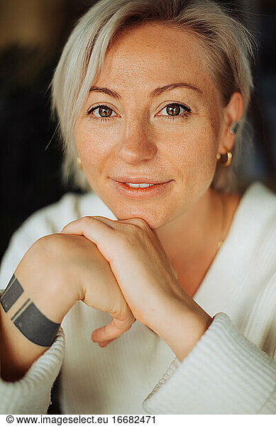 Headshot of a blond woman with short hair looking at camera