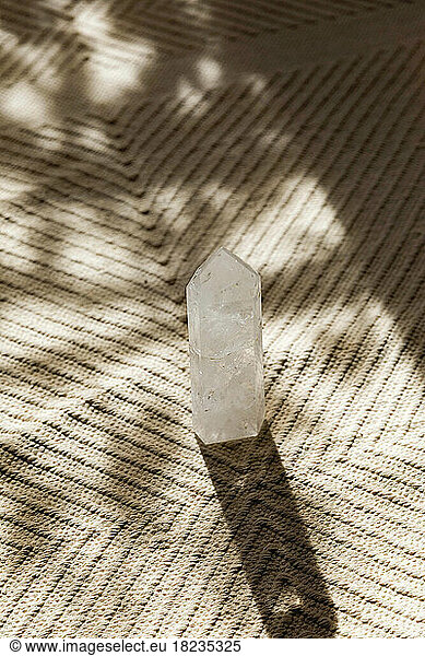 Healing crystal on carpet in sunlight