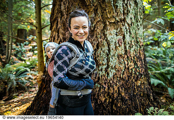 Healthy and fit mother wearing baby carrier  hiking