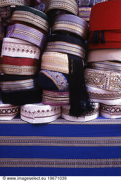 Heap of fancy embroidered skullcaps placed on the table.