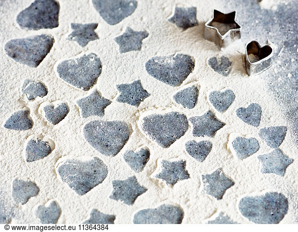 Heart and star shapes patterns in flour with cookie cutters