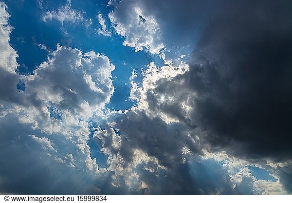 Heavenly Sun Rays Through Dark Clouds Against The Blue Sky. selective focus.