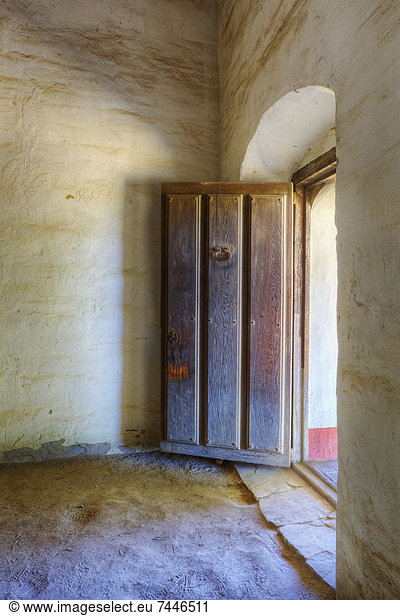 Heavy wood door to an adobe building at Mission La Purisima State Historic Park  Lompoc  California  Founded in 1787  the eleventh mission of the twenty-one Spanish Missions established in California