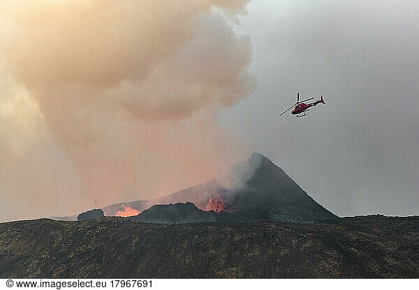 Helicopter flying over smoking active volcanic crater  glowing lava  volcanic eruption  active table volcano Fagradalsfjall  Krýsuvík volcanic system  Reykjanes Peninsula  Iceland  Europe