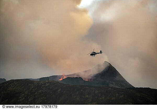 Helicopter flying over smoking active volcanic crater  glowing lava  volcanic eruption  active table volcano Fagradalsfjall  Krýsuvík volcanic system  Reykjanes Peninsula  Iceland  Europe