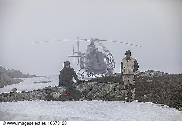 Helicopter pilot and passenger wait for improved weather  stranded.