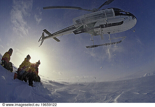 helicopter taking off while heli skiing  Alaska