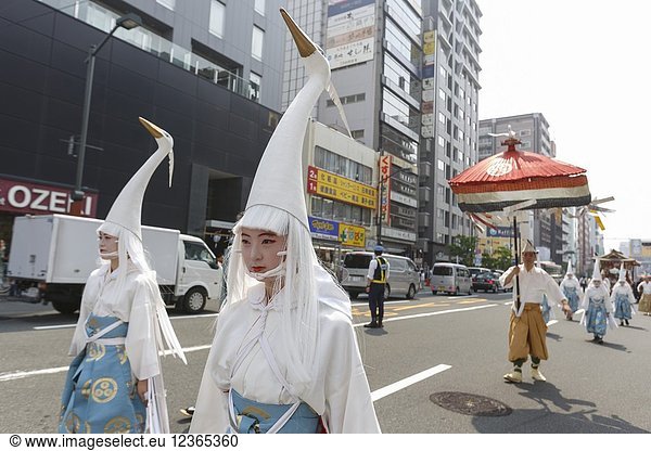 Heron hooded dancers walk towards Sensoji Temple during the Daigyoretsu or Large Parade of Sanja Matsuri Festival in Asakusa on May 18  2018  Tokyo  Japan. The Daigyoretsu Parade is a large procession of priest  city officials  musicians  geishas and dancers dressing Edo Period costumes through Asakusa streets until Sensoji Temple. This is one of the Three Great Shinto Festivals in Tokyo  that is held on the third weekend of May.