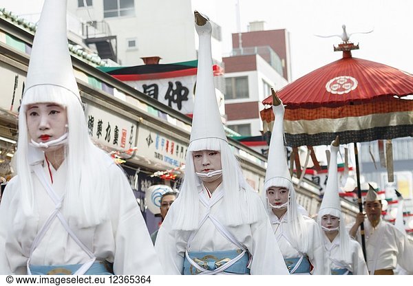 Heron hooded dancers walk towards Sensoji Temple during the Daigyoretsu or Large Parade of Sanja Matsuri Festival in Asakusa on May 18  2018  Tokyo  Japan. The Daigyoretsu Parade is a large procession of priest  city officials  musicians  geishas and dancers dressing Edo Period costumes through Asakusa streets until Sensoji Temple. This is one of the Three Great Shinto Festivals in Tokyo  that is held on the third weekend of May.
