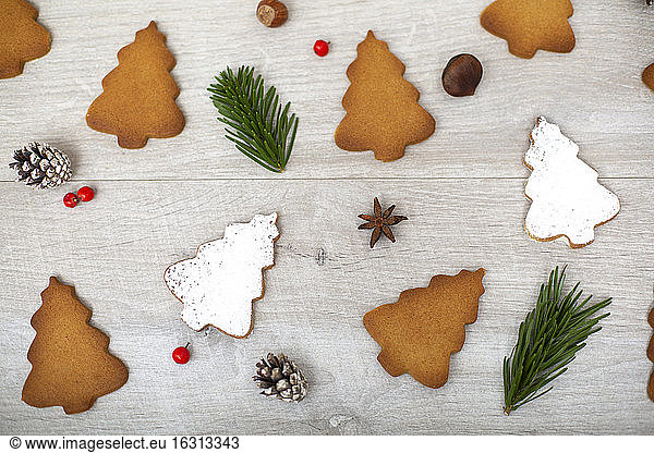 High angle close up of Christmas decorations and Christmas Tree cookies.