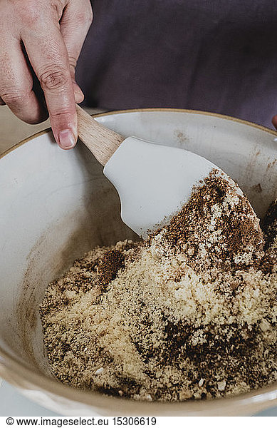 High angle close up of person mixing baking ingredients using spatula.
