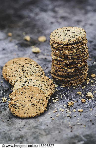 High angle close up of stack of freshly baked seeded crackers.