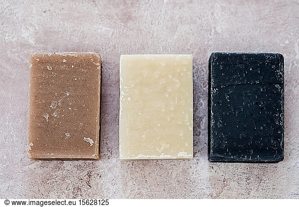 High angle close up of three bars of homemade bars of soap.
