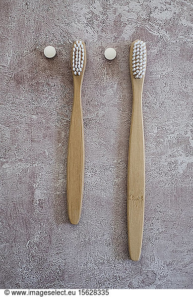 High angle close up of two wooden toothbrushes.