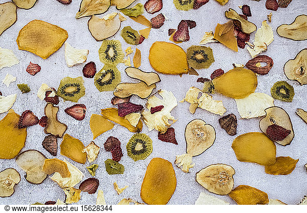 High angle close up slices of dried fruit including mango  apple  kiwi and strawberry.