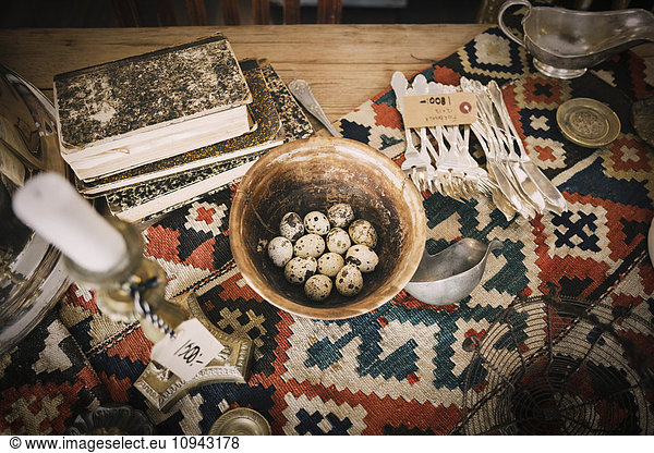 High angle view of antique objects on table in store