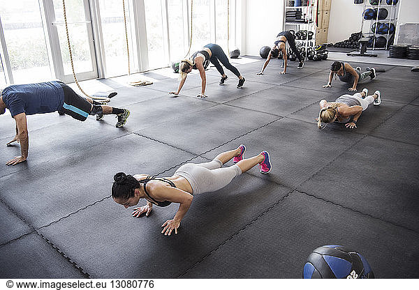 High angle view of athletes doing push-ups in crossfit gym